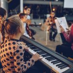 Group of kids teaching to play instruments in music school